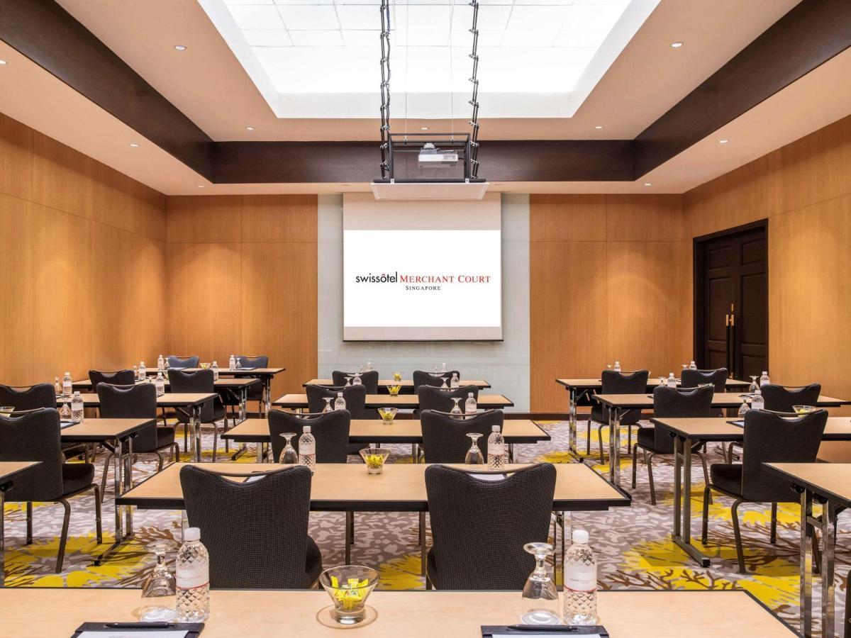 Paradox Singapore Merchant Court At Clarke Quay Екстериор снимка The image shows a conference room setup. It features rows of tables arranged with chairs, creating a professional space suitable for meetings or presentations. In the front of the room, there is a large screen set against a light-colored wall, likely