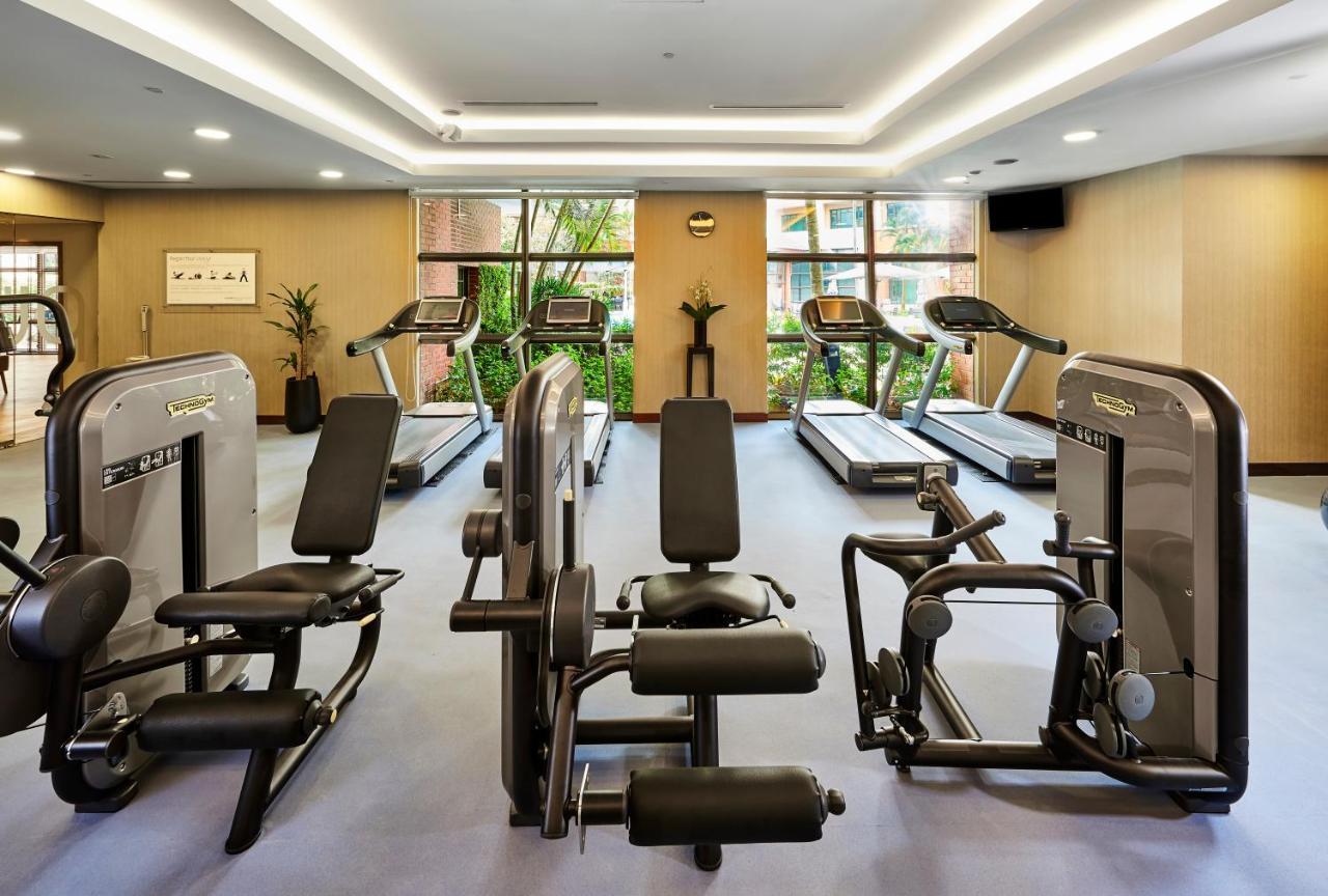 Paradox Singapore Merchant Court At Clarke Quay Екстериор снимка The photo shows a gym or fitness center with various exercise equipment. There are several treadmills positioned against large windows that let in natural light, and some strength training machines are arranged in the space. The gym has a modern desi