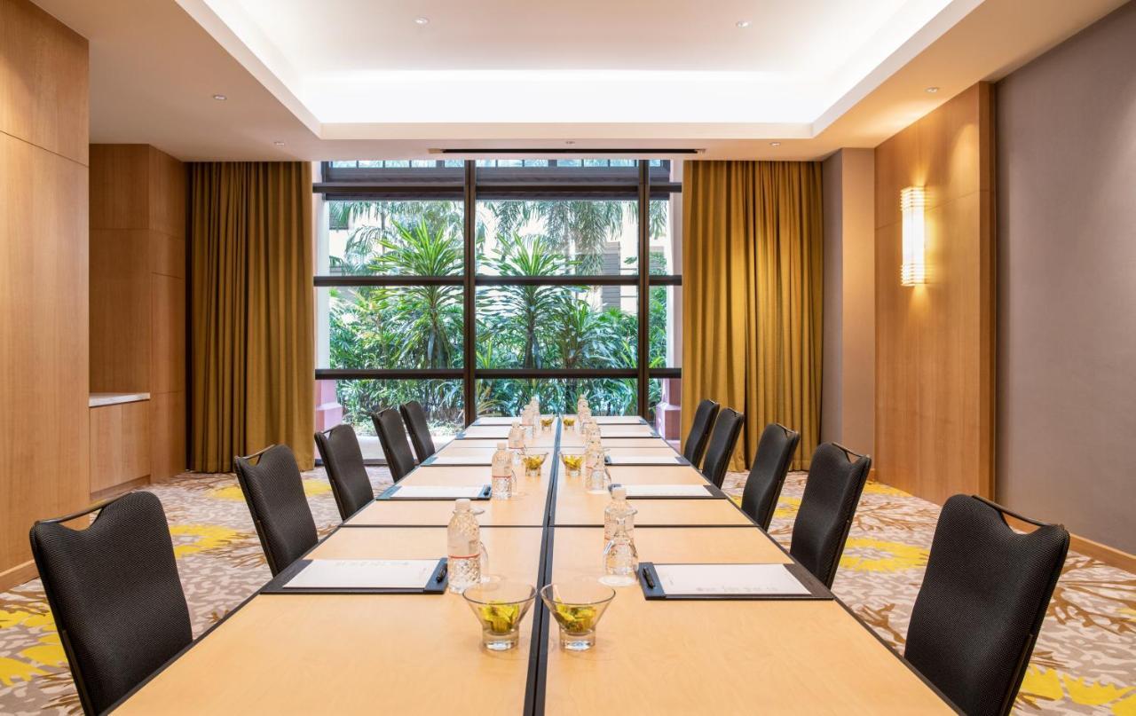 Paradox Singapore Merchant Court At Clarke Quay Екстериор снимка The photo shows a modern conference room with a long rectangular table set up for a meeting. The table is topped with water bottles and small decorative bowls, possibly containing snacks or centrepieces. The room features large windows that provide a