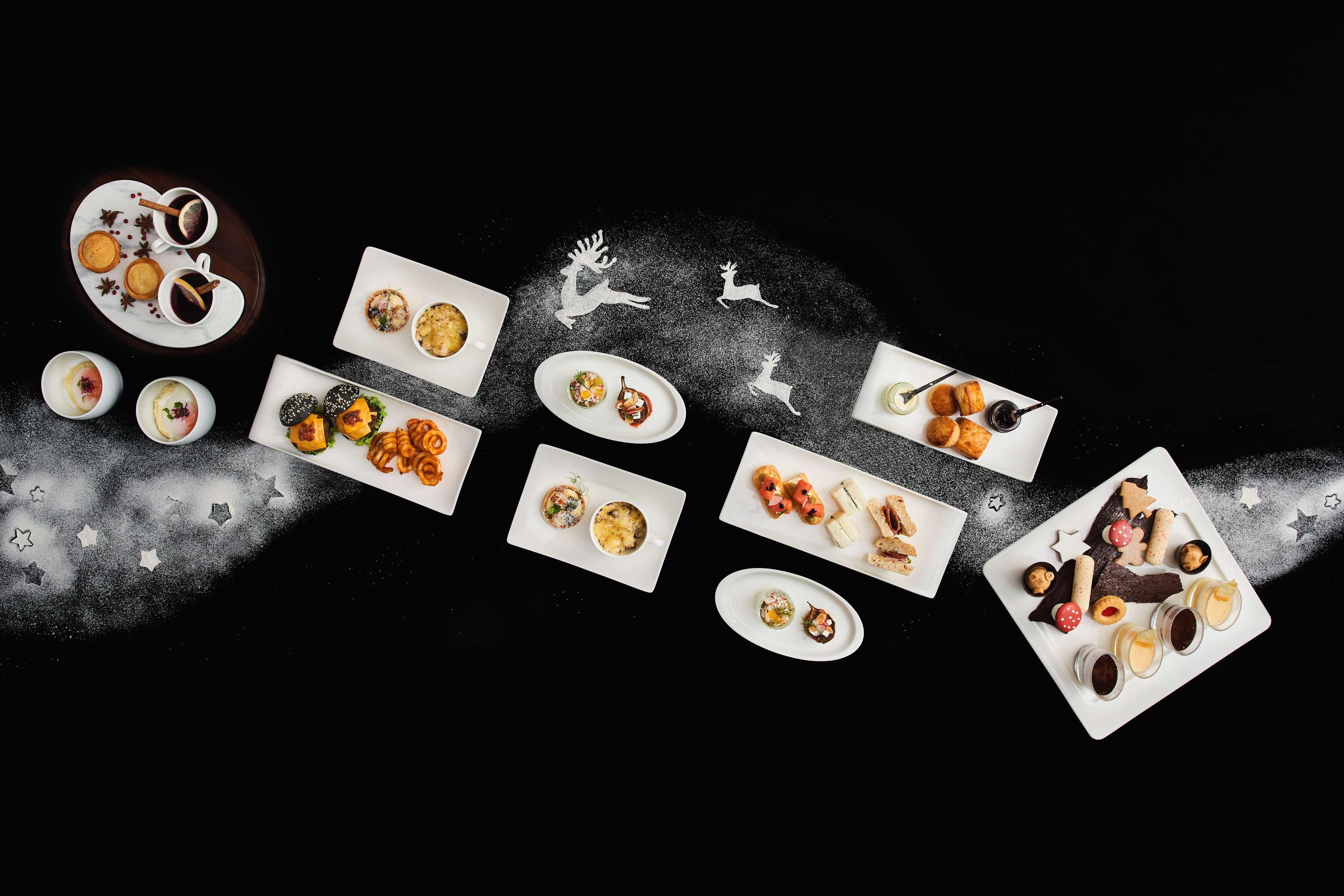 Paradox Singapore Merchant Court At Clarke Quay Екстериор снимка The photo features an artistic arrangement of various gourmet dishes presented on white plates against a dark background. The dishes include a mix of desserts and appetizers, showcasing vibrant colors and intricate designs. Some plates contain small 