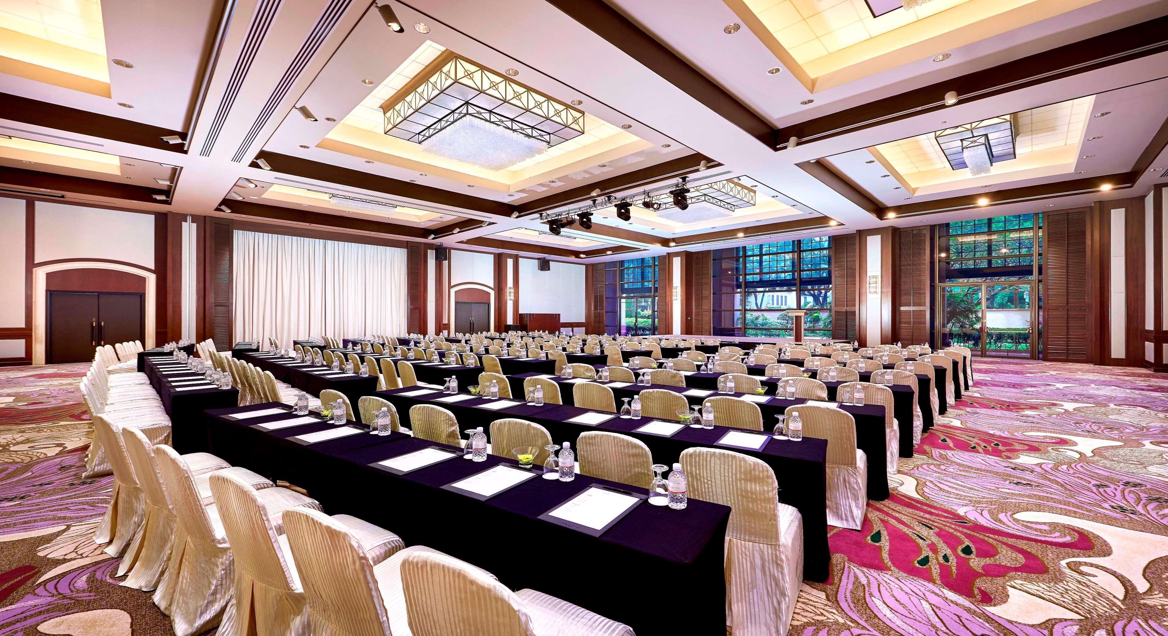Paradox Singapore Merchant Court At Clarke Quay Екстериор снимка The photo shows a large conference room set up for an event or meeting. The room features multiple rows of tables covered with black cloths and arranged with chairs. Each table has water glasses and what appears to be notepads or documents. The space